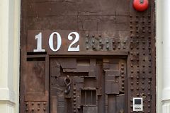 16-2 Steel Sculpture Door at 102 Greene St Designed by William Tarr - The hook Is The Door Knocker, the Barred Square Opens From The Inside In SoHo New York City.jpg